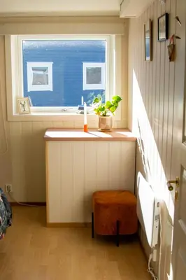 a small kitchen with a sink and a window at Cosy house with sunny terrace, garden and fjord view in Bergen