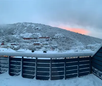 a view from the roof of a building in the snow at Cosy house with sunny terrace, garden and fjord view in Bergen
