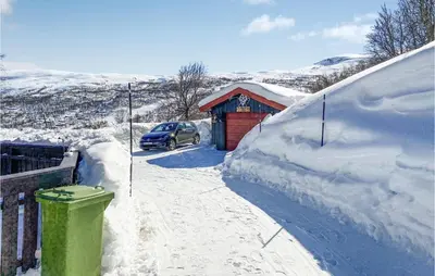 a car parked in front of a snow covered shed at Stunning Home In Tyinkrysset in Tyinkrysset