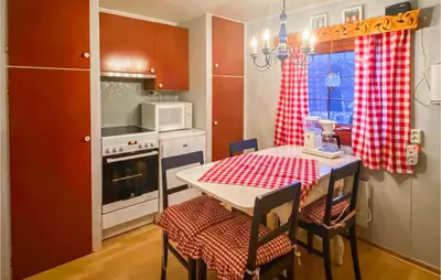 a kitchen with a table with a red checkered table cloth at Stunning Home In Tyinkrysset in Tyinkrysset