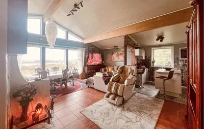 a bedroom with a bed and a living room at Cozy Home In Vevang With Sauna in Vevang