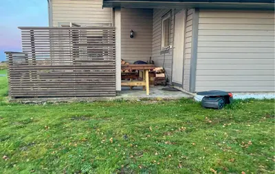 a picnic table sitting on the side of a house at Cozy Home In Vevang With Sauna in Vevang