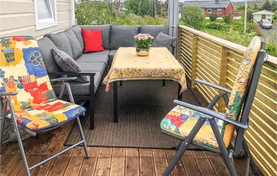 a patio with a couch and two chairs and a table at Lovely Home In Smøla With Kitchen in Smøla