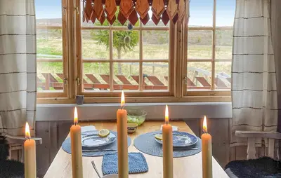 a table with candles on it in front of a window at 3 Bedroom Lovely Home In Vinstra in Vinstra