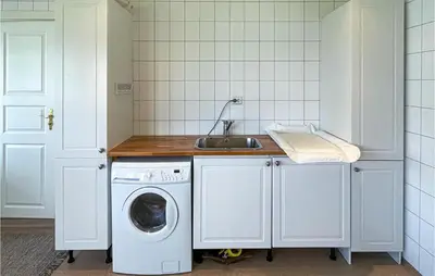 a kitchen with a washing machine and a sink at Lovely Home In Bjoneroa With Wifi in Bjoneroa
