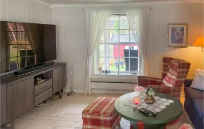 a living room with a tv and a table at Lovely Home In Bjoneroa With Wifi in Bjoneroa