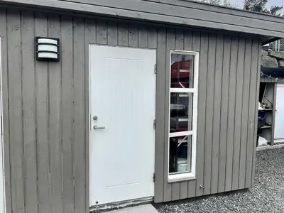 a garage with a white door and a window at 6 person holiday home in Huglo-By Traum in Nordhuglo