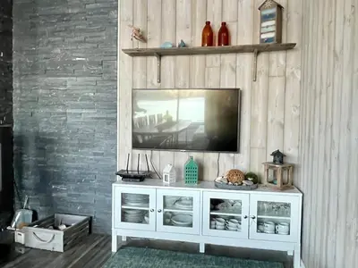 a television sitting on top of a white cabinet at 6 person holiday home in Huglo-By Traum in Nordhuglo