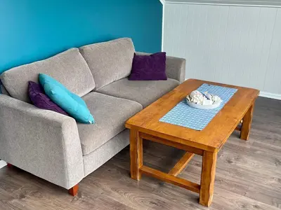a living room with a couch and a coffee table at 6 person holiday home in Huglo-By Traum in Nordhuglo