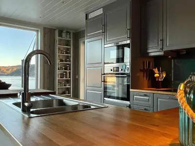 a kitchen with a sink and a counter with a window at 6 person holiday home in Huglo-By Traum in Nordhuglo