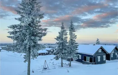 a cabin in the snow with snow covered trees at Beautiful Home In Sjusjøen With Wifi in Sjusjøen