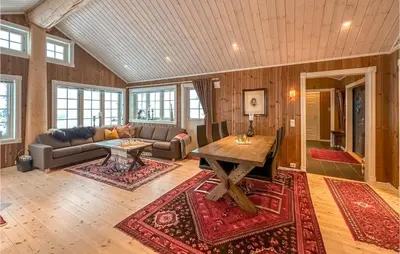 a living room with a couch and a table at Beautiful Home In Sjusjøen With Wifi in Sjusjøen