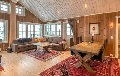 a living room with a couch and a table at Beautiful Home In Sjusjøen With Wifi in Sjusjøen
