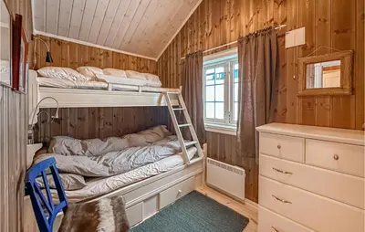 a room with two bunk beds and a window at Beautiful Home In Sjusjøen With Wifi in Sjusjøen