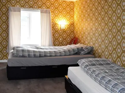 two twin beds in a bedroom with a window at 8 person holiday home in Snillfjord-By Traum in Snillfjord