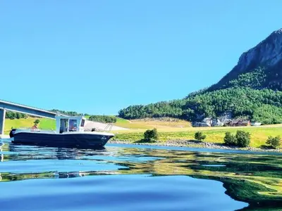 a boat on the water under a bridge at 8 person holiday home in Snillfjord-By Traum in Snillfjord