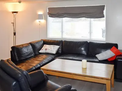 a living room with a leather couch and a coffee table at 8 person holiday home in Snillfjord-By Traum in Snillfjord