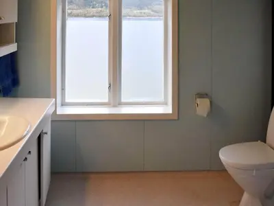 a bathroom with a sink and a toilet and a window at 8 person holiday home in Snillfjord-By Traum in Snillfjord