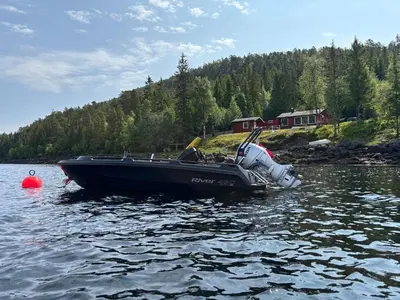 a boat sitting in the water on a lake at 9 person holiday home in Mosvik-By Traum in Mosvik