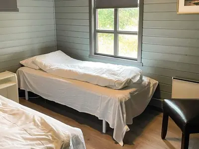 a room with two beds and a window at 12 person holiday home in Selje-By Traum in Selje