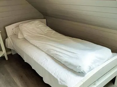 a bed in a room with white sheets and pillows at 12 person holiday home in Selje-By Traum in Selje