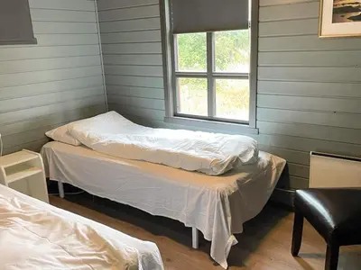 two beds in a room with a window at 12 person holiday home in Selje-By Traum in Selje
