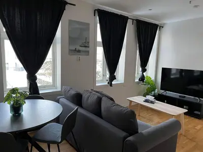 a living room with a couch and a table at Fløyen Apartment in Bergen