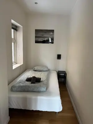 a bedroom with a bed in a room at Fløyen Apartment in Bergen