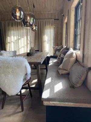 a living room with a couch and a table at Beautifully styled mountain lodge with high standards, 10 minutes from Geilo in Geilo