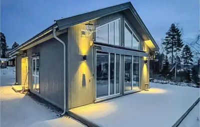 a house with a lot of windows in the snow at 3 Bedroom Gorgeous Home In Brøttum