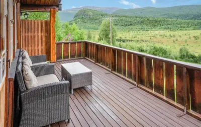 a balcony with wicker chairs and a table and a view at Awesome Home In Hemsedal With Wifi in Hemsedal