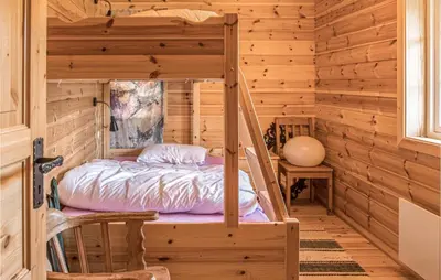 a bedroom with a bunk bed in a log cabin at 3 Bedroom Nice Home In Oppdal in Oppdal
