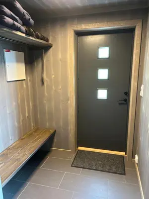 a door in a room with a bench next to it at Vangslia, Oppdal. Lekker leilighet med ski inn/ski ut in Oppdal