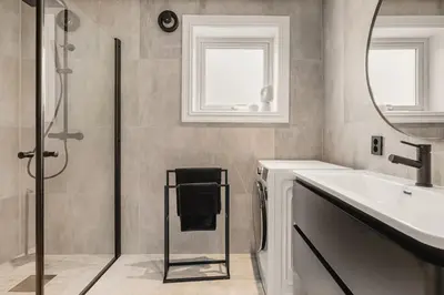 a bathroom with a shower and a sink and a mirror at Odda View - 4BR & 2BR & 1BR - B11 in Odda