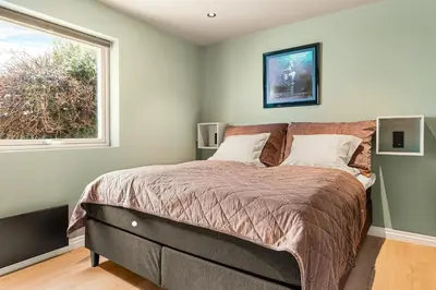 a bedroom with a large bed and a window at Odda View - 4BR & 2BR & 1BR - B11 in Odda