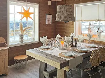 a dining room with a table and a star on the window at 7 person holiday home in Rauland-By Traum in Rauland