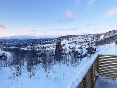 a view of a snow covered mountain with houses at 7 person holiday home in Rauland-By Traum in Rauland