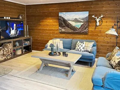 a living room with a blue couch and a coffee table at 7 person holiday home in Rauland-By Traum in Rauland