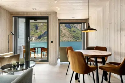 a dining room with a table and a view of the ocean at Wangen Apartments in Aurland