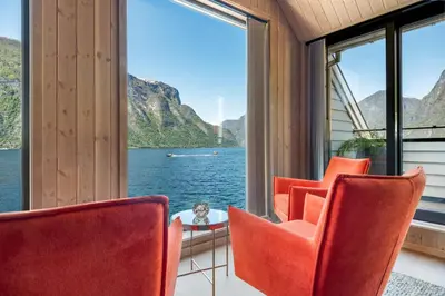 a room with a view of the water and mountains at Wangen Apartments in Aurland