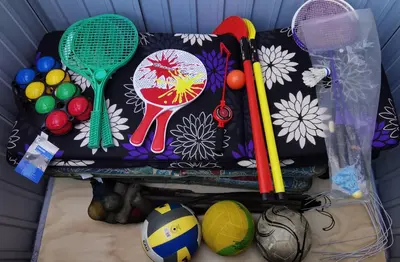 a bag filled with tennis balls and tennis rackets at Alone In The Woods With Your Own River Nearby in Fitjar
