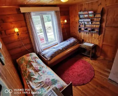 a room with a bench and a window in a cabin at Alone In The Woods With Your Own River Nearby in Fitjar