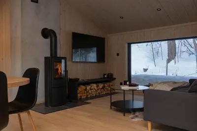 a living room with a fireplace and a couch at High standard cabin close to the Flå city center in Flå