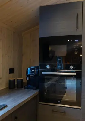 a kitchen with a stove and a microwave at High standard cabin close to the Flå city center in Flå