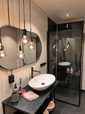 a bathroom with a sink and a glass shower at Skogro ved Norefjell in Noresund