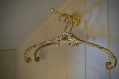 a gold towel rack hanging on a wall at Jugend 1905 in Ålesund