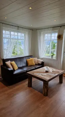 a living room with a couch and a coffee table at Haramsøy Holiday Apartment- Island Life North in Haram