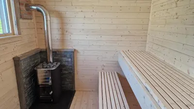 a sauna with two benches in a room at Haramsøy Holiday Apartment- Island Life North in Haram