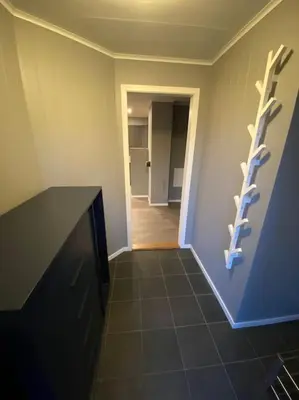 a room with a black counter and a hallway at Cozy apartment near Besseggen with a private sauna in Randsverk