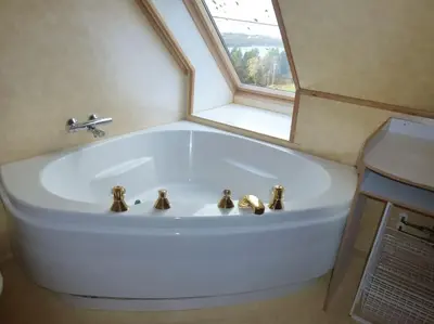 a white bath tub in a bathroom with a window at Topfloor Apartment Separate Entranc Nice view Stord in Fitjar